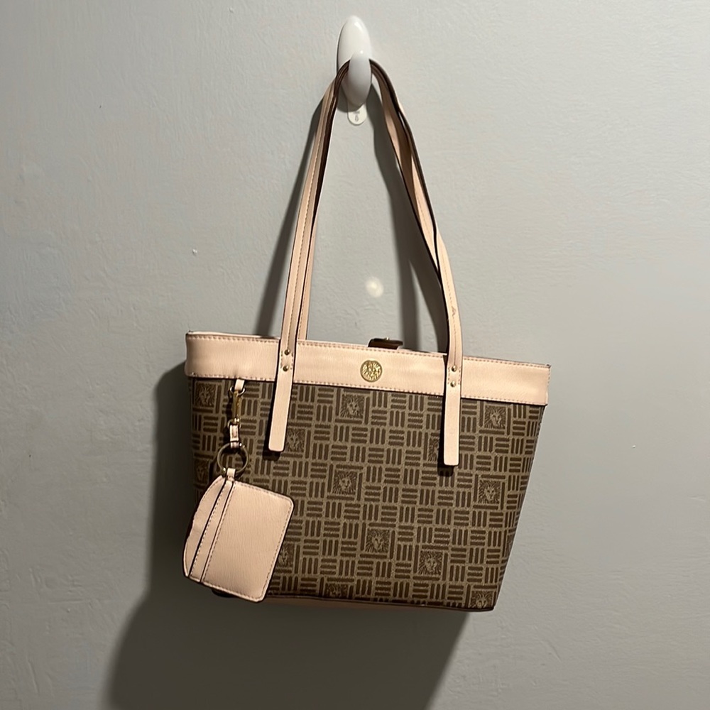 A gently used Anne Klein bag. contains a mini wallet and a regular sized wallet.